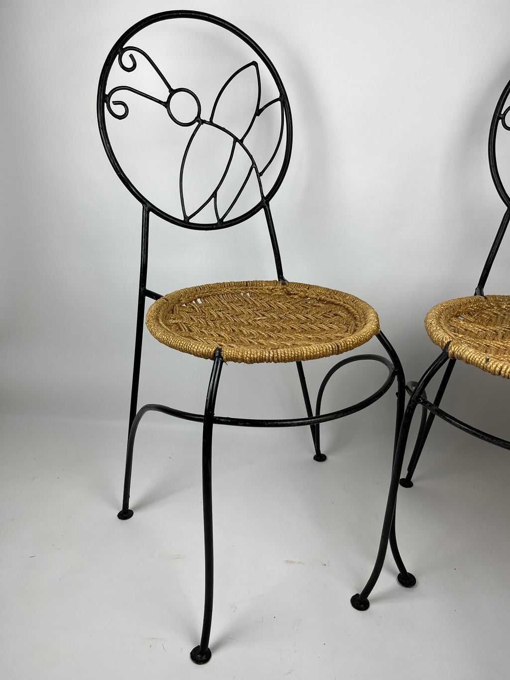 A PAIR OF WROUGHT IRON 'BUTTERFLY' DESIGN CHAIRS