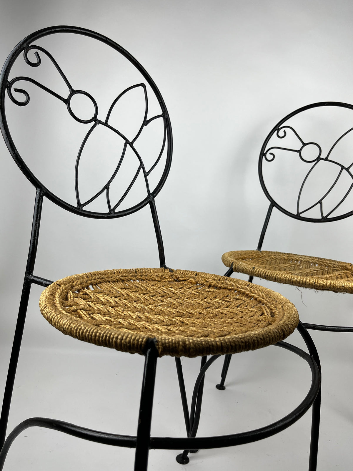 A PAIR OF WROUGHT IRON 'BUTTERFLY' DESIGN CHAIRS